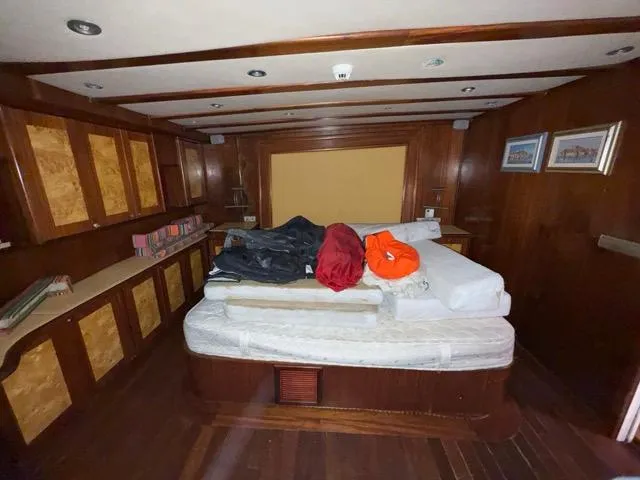 42 M Custom Made Motorsailor Yacht Photos Pics Luxurious cabin interior of 2006 Custom Made 42 M Motorsailor with wood paneling and cozy bed.