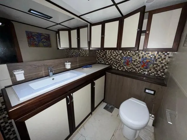 42 M Custom Made Motorsailor Yacht Photos Pics Luxurious bathroom on a 2006 Custom Made 42 M Motorsailor with modern fixtures and mosaic tiles.