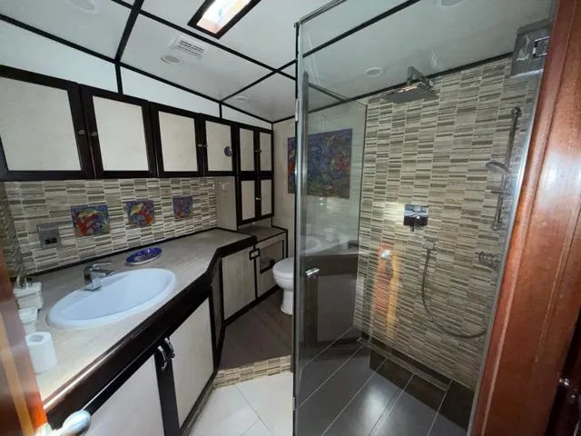 42 M Custom Made Motorsailor Yacht Photos Pics Luxurious bathroom in 2006 Custom Made 42 M Motorsailor with modern shower and elegant cabinetry.