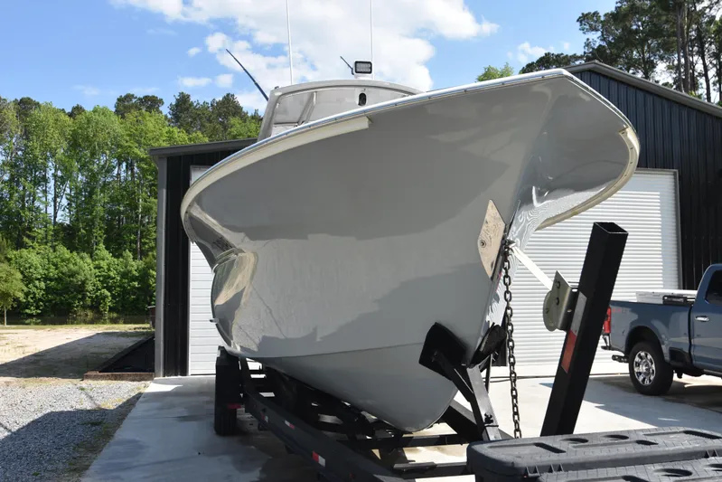 Double Trouble Yacht Photos Pics Custom Carolina 28 Cape Lookout boat on trailer, 2007 model, repowered in 2019, outdoors.