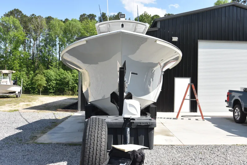 Double Trouble Yacht Photos Pics Custom Carolina 28 Cape Lookout boat, 2007 model, repowered in 2019, parked near a garage.