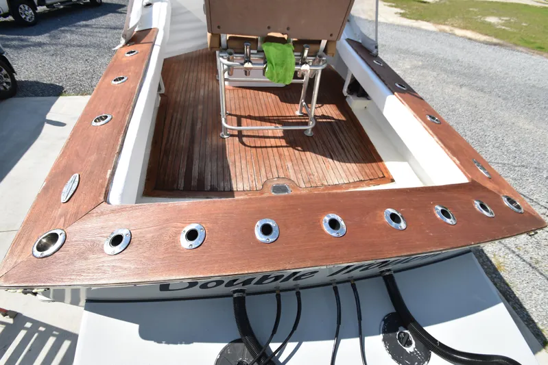 Double Trouble Yacht Photos Pics Custom Carolina 28 Cape Lookout boat deck, 2007 model, repowered in 2019, featuring wooden finish.