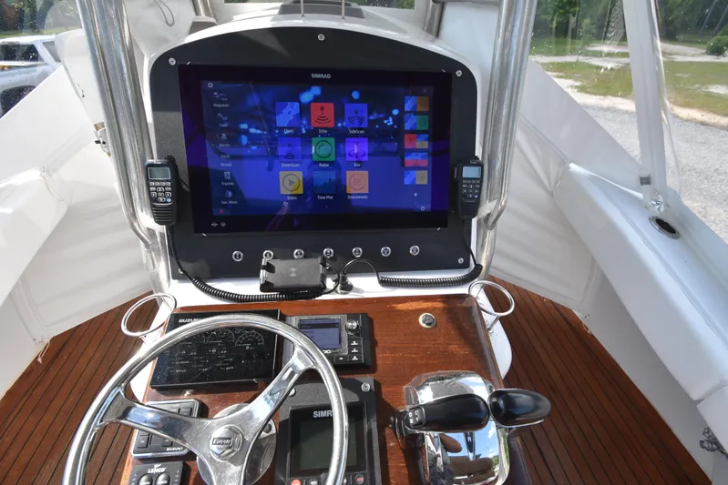 Double Trouble Yacht Photos Pics Helm of 2007 Custom Carolina 28 Cape Lookout with modern navigation system.