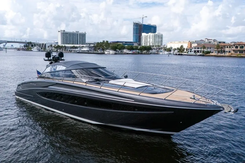  Yacht Photos Pics Luxurious 2015 Riva 63 yacht cruising on a scenic waterfront with city skyline.
