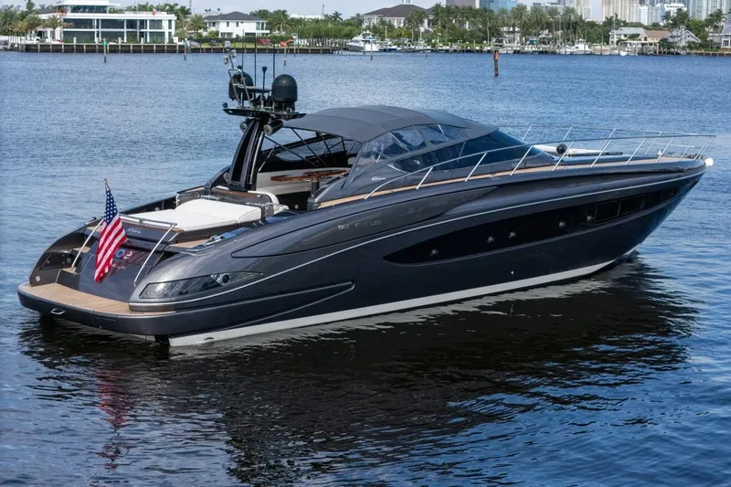  Yacht Photos Pics Luxury 2015 Riva 63 yacht on calm water with American flag displayed.