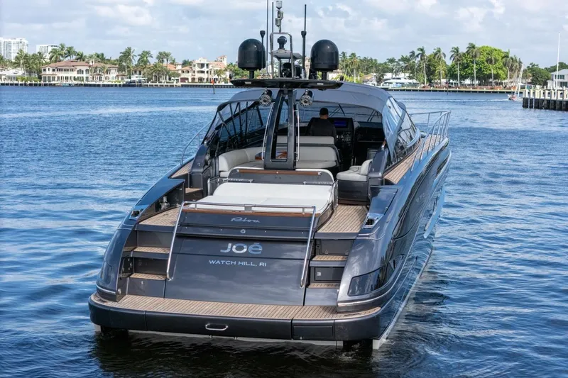  Yacht Photos Pics Luxury 2015 Riva 63 yacht on serene water, showcasing elegant design and craftsmanship.