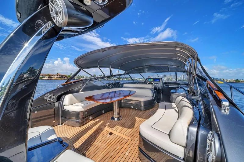  Yacht Photos Pics Luxurious 2015 Riva 63 yacht interior with elegant seating and wooden deck under clear blue sky.