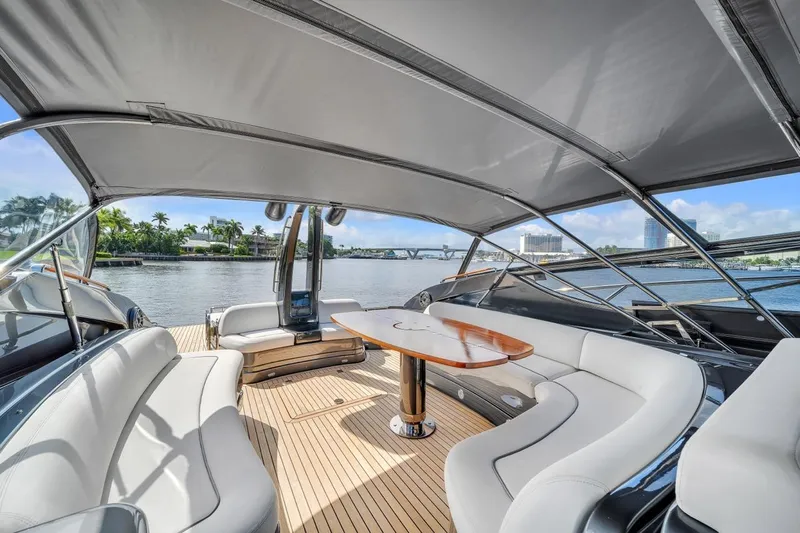  Yacht Photos Pics Luxurious 2015 Riva 63 yacht interior with elegant seating and scenic waterfront view.