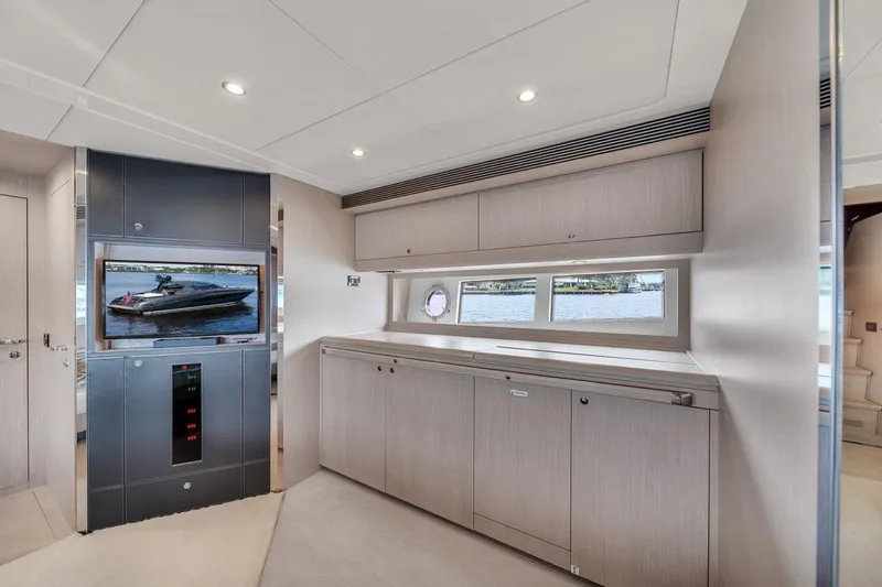  Yacht Photos Pics Luxurious interior of 2015 Riva 63 yacht with modern cabinetry and scenic window view.