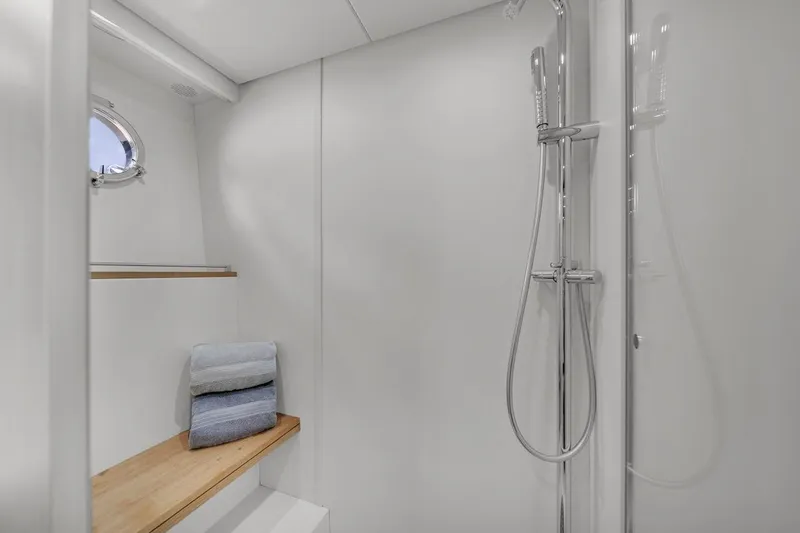  Yacht Photos Pics Luxurious 2015 Riva 63 yacht bathroom with modern shower and wooden bench.