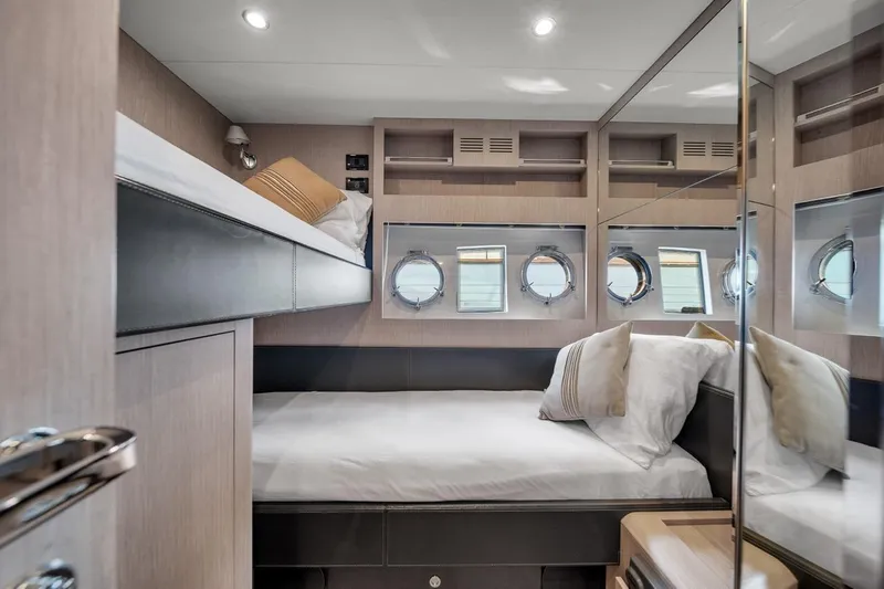  Yacht Photos Pics Luxurious cabin interior of 2015 Riva 63 yacht with modern design and porthole windows.