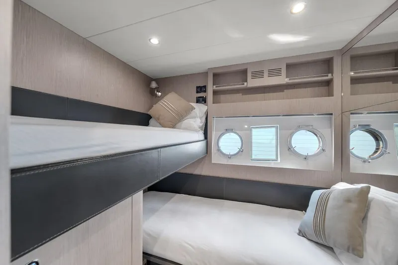  Yacht Photos Pics Luxurious 2015 Riva 63 yacht cabin with bunk beds and porthole windows.