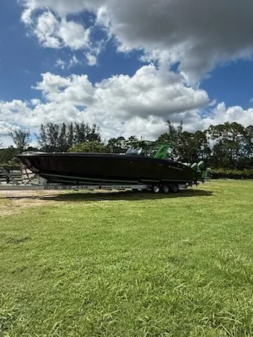  Yacht Photos Pics 2020 Midnight Express Open 43 boat on trailer under cloudy sky.