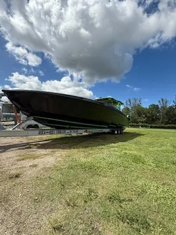  Yacht Photos Pics 2020 Midnight Express Open 43 boat on trailer under cloudy sky.
