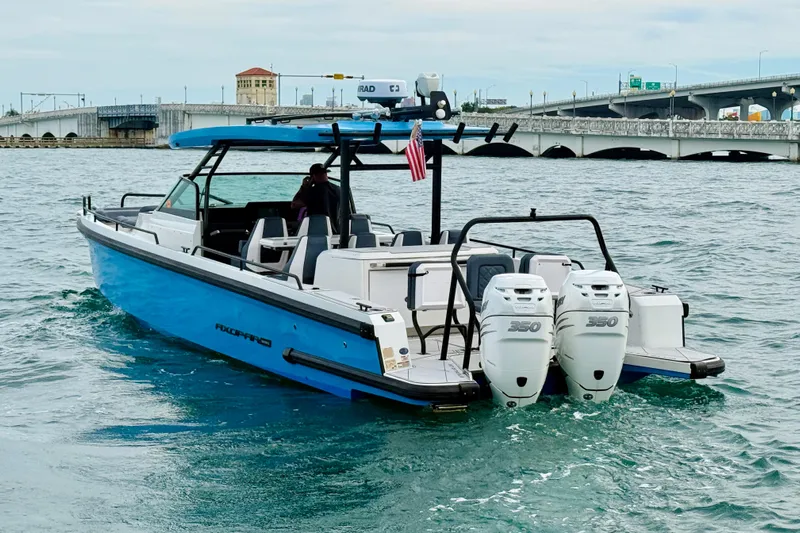 Out Of The Blue Yacht Photos Pics 2021 Axopar 37 Sun Top boat cruising near a bridge with twin 350 engines.