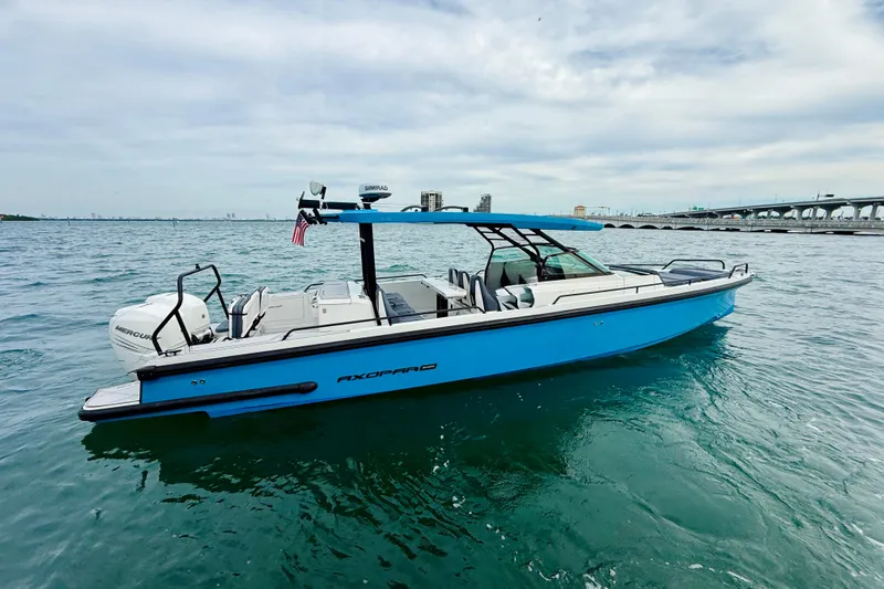 Out Of The Blue Yacht Photos Pics 2021 Axopar 37 Sun Top boat on water, featuring sleek design and vibrant blue color.
