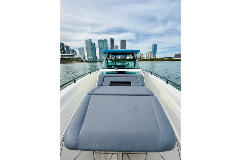 Out Of The Blue Yacht Photos Pics 2021 Axopar 37 Sun Top boat with city skyline in the background.