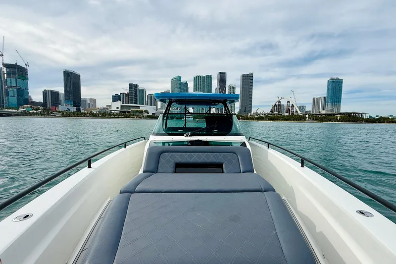Out Of The Blue Yacht Photos Pics 2021 Axopar 37 Sun Top boat with city skyline in the background.