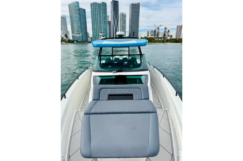 Out Of The Blue Yacht Photos Pics 2021 Axopar 37 Sun Top boat with city skyline in the background.