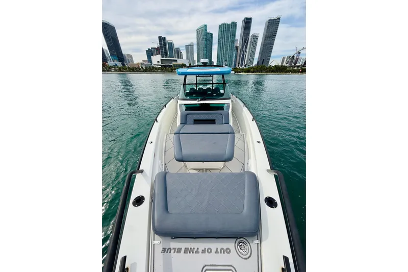 Out Of The Blue Yacht Photos Pics 2021 Axopar 37 Sun Top boat with city skyline in the background.