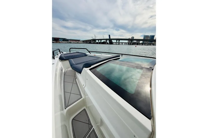 Out Of The Blue Yacht Photos Pics 2021 Axopar 37 Sun Top boat with sleek design on calm waters.