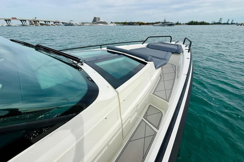 Out Of The Blue Yacht Photos Pics 2021 Axopar 37 Sun Top boat on water, featuring sleek design and spacious deck.