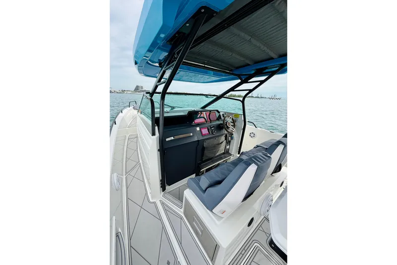 Out Of The Blue Yacht Photos Pics 2021 Axopar 37 Sun Top boat interior with modern helm and seating on open water.