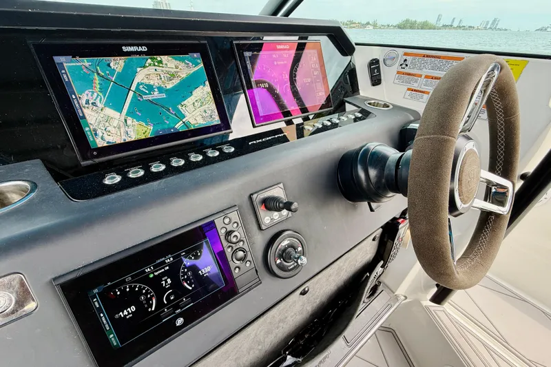 Out Of The Blue Yacht Photos Pics 2021 Axopar 37 Sun Top dashboard with navigation screens and steering wheel.