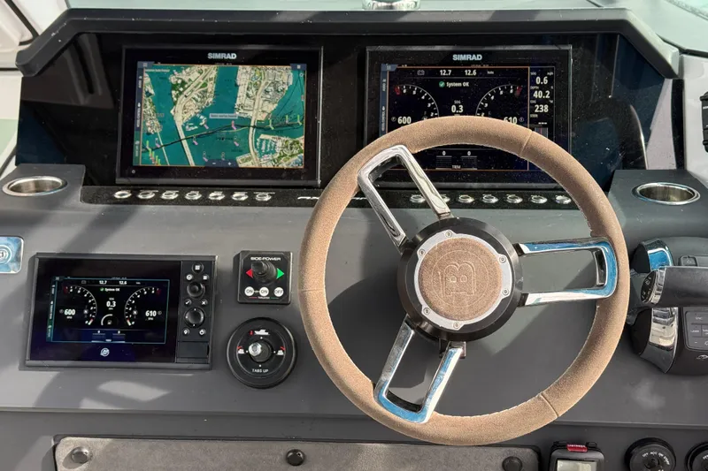 Out Of The Blue Yacht Photos Pics Steering console of 2021 Axopar 37 Sun Top with navigation displays and controls.