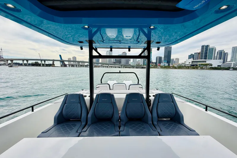 Out Of The Blue Yacht Photos Pics 2021 Axopar 37 Sun Top boat with city skyline and water view.