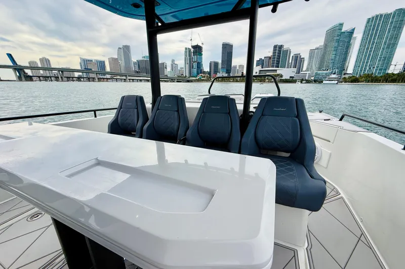 Out Of The Blue Yacht Photos Pics 2021 Axopar 37 Sun Top boat interior with city skyline in background.