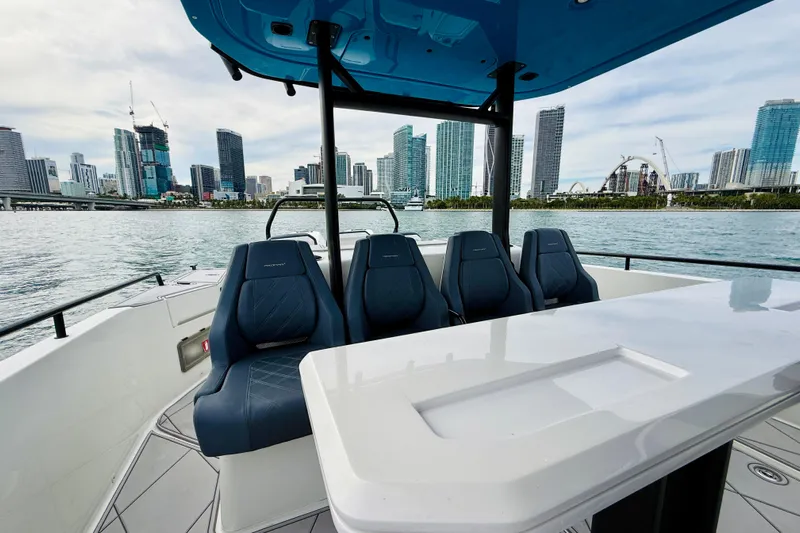Out Of The Blue Yacht Photos Pics 2021 Axopar 37 Sun Top boat with city skyline in the background.