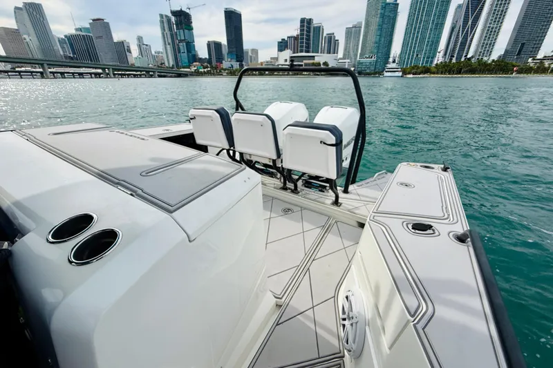 Out Of The Blue Yacht Photos Pics 2021 Axopar 37 Sun Top boat with city skyline in the background.