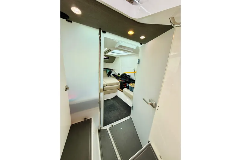 Out Of The Blue Yacht Photos Pics Interior view of 2021 Axopar 37 Sun Top cabin with seating and modern design.