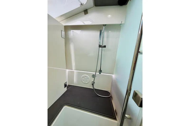 Out Of The Blue Yacht Photos Pics 2021 Axopar 37 Sun Top boat shower interior with modern fixtures and sleek design.