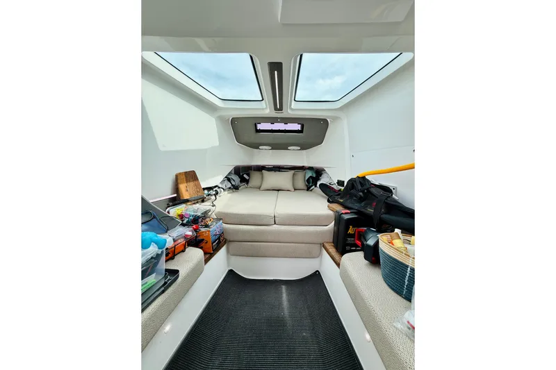 Out Of The Blue Yacht Photos Pics Interior of 2021 Axopar 37 Sun Top boat with cozy seating and storage.