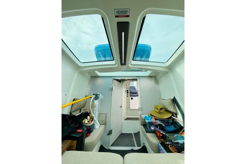 Out Of The Blue Yacht Photos Pics Interior view of 2021 Axopar 37 Sun Top boat with skylights and seating area.