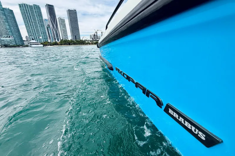 Out Of The Blue Yacht Photos Pics 2021 Axopar 37 Sun Top boat cruising near city skyline.