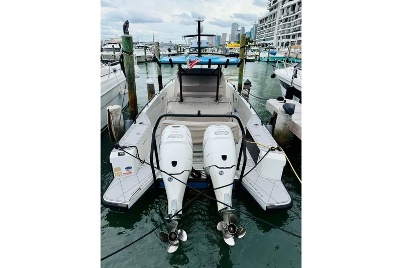 Out Of The Blue Yacht Photos Pics 2023 Axopar 37 Sun Top boat docked with dual outboard engines.