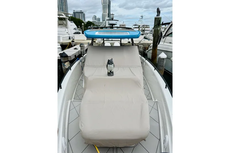 Out Of The Blue Yacht Photos Pics 2023 Axopar 37 Sun Top boat with covered seating at a marina.
