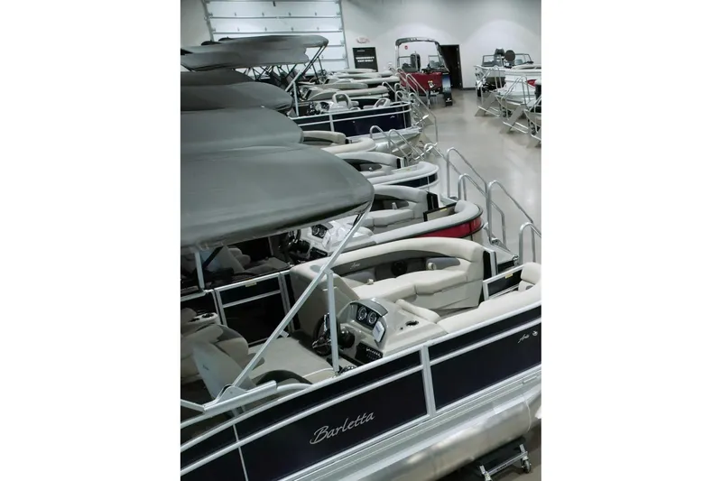  Yacht Photos Pics 2026 Barletta Lusso 23UCA pontoon boats displayed in a showroom.