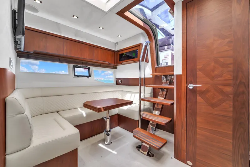  Yacht Photos Pics Interior of 2017 Galeon 445 HTS yacht with wooden finishes and white seating.