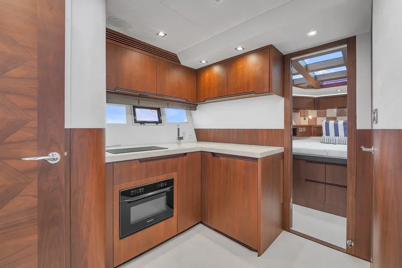  Yacht Photos Pics Modern kitchen in 2017 Galeon 445 HTS yacht with wood cabinetry and built-in appliances.