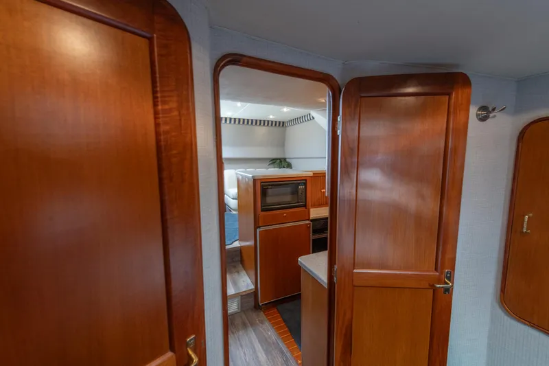 Alexa Corinne Yacht Photos Pics Interior of 1999 Ocean Yachts 48 Express, featuring wooden cabinetry and modern kitchen amenities.