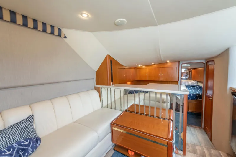 Alexa Corinne Yacht Photos Pics Luxurious interior of 1999 Ocean Yachts 48 Express with elegant seating and wooden cabinetry.