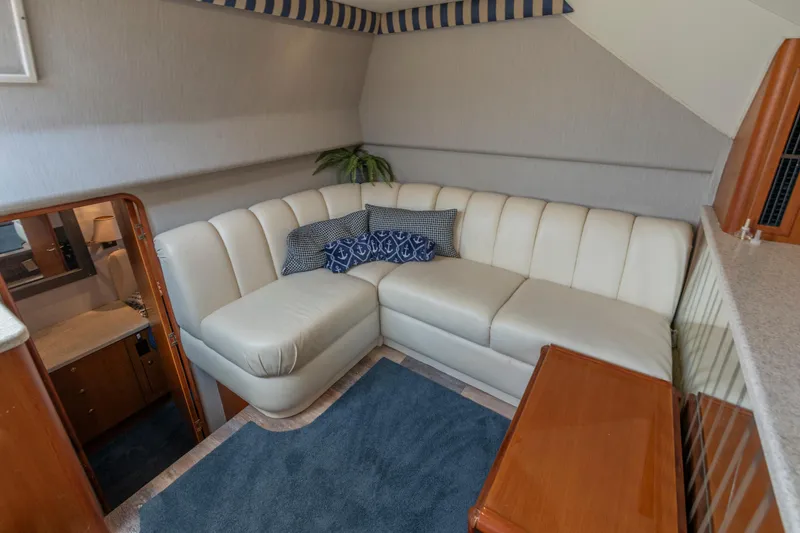 Alexa Corinne Yacht Photos Pics Luxurious interior of 1999 Ocean Yachts 48 Express with white leather seating and nautical decor.