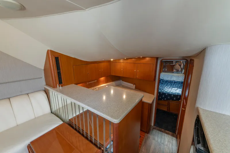 Alexa Corinne Yacht Photos Pics 1999 Ocean Yachts 48 Express interior with modern kitchen and cozy cabin.