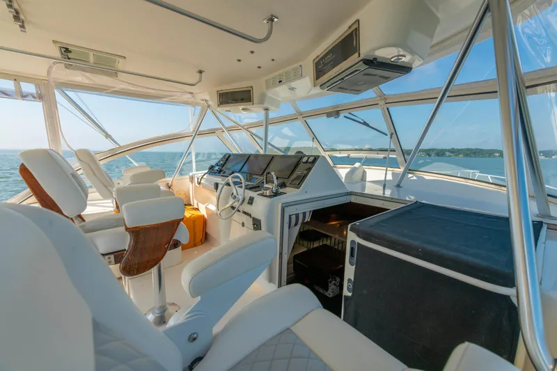 Alexa Corinne Yacht Photos Pics Interior of 1999 Ocean Yachts 48 Express, featuring helm and seating with ocean view.