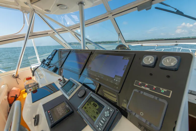 Alexa Corinne Yacht Photos Pics Cockpit view of 1999 Ocean Yachts 48 Express, featuring navigation instruments and ocean scenery.