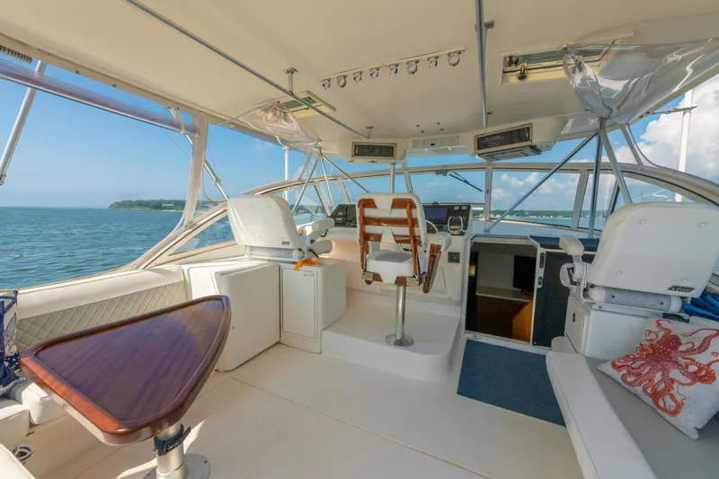 Alexa Corinne Yacht Photos Pics 1999 Ocean Yachts 48 Express interior with helm, seating, and ocean view.